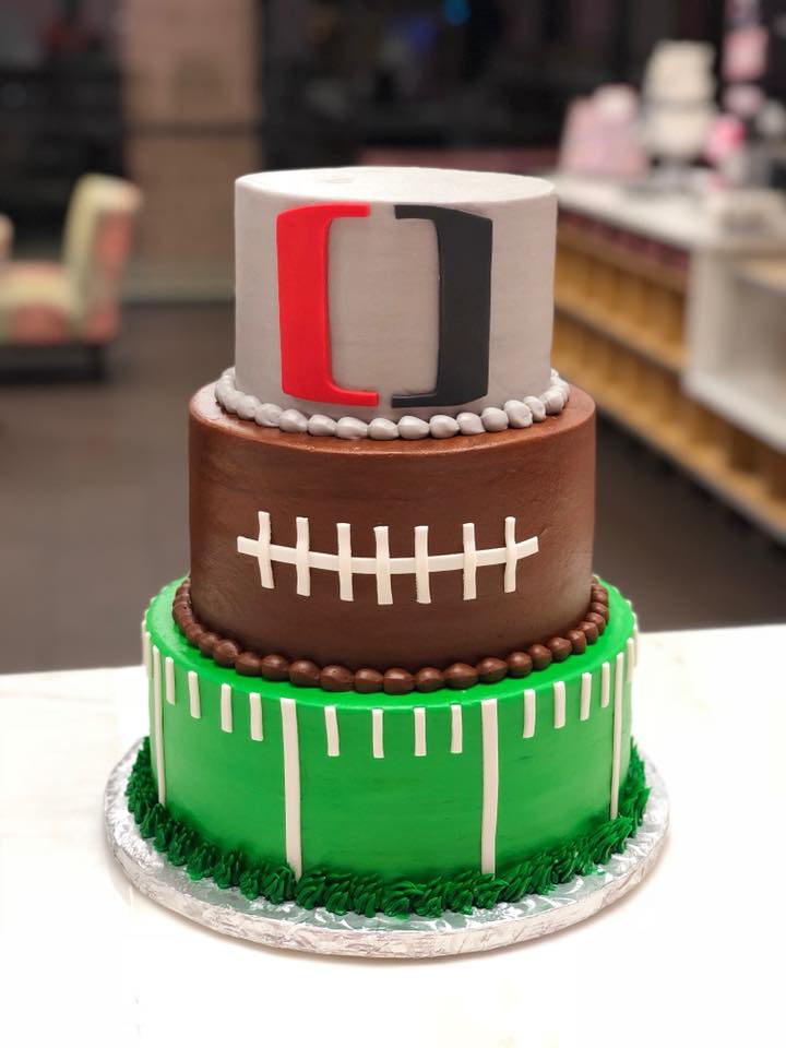 Three-tier Miami Hurricanes football themed cake