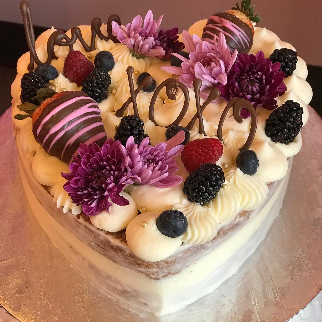 Heart-shaped naked cake with berries, florals & chocolate XOXO
