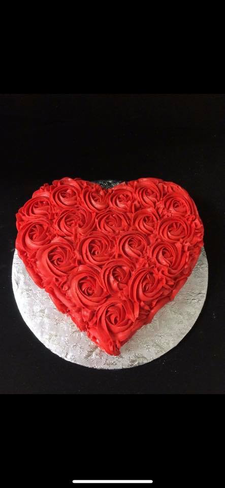 Red rosette heart-shaped Valentine cake